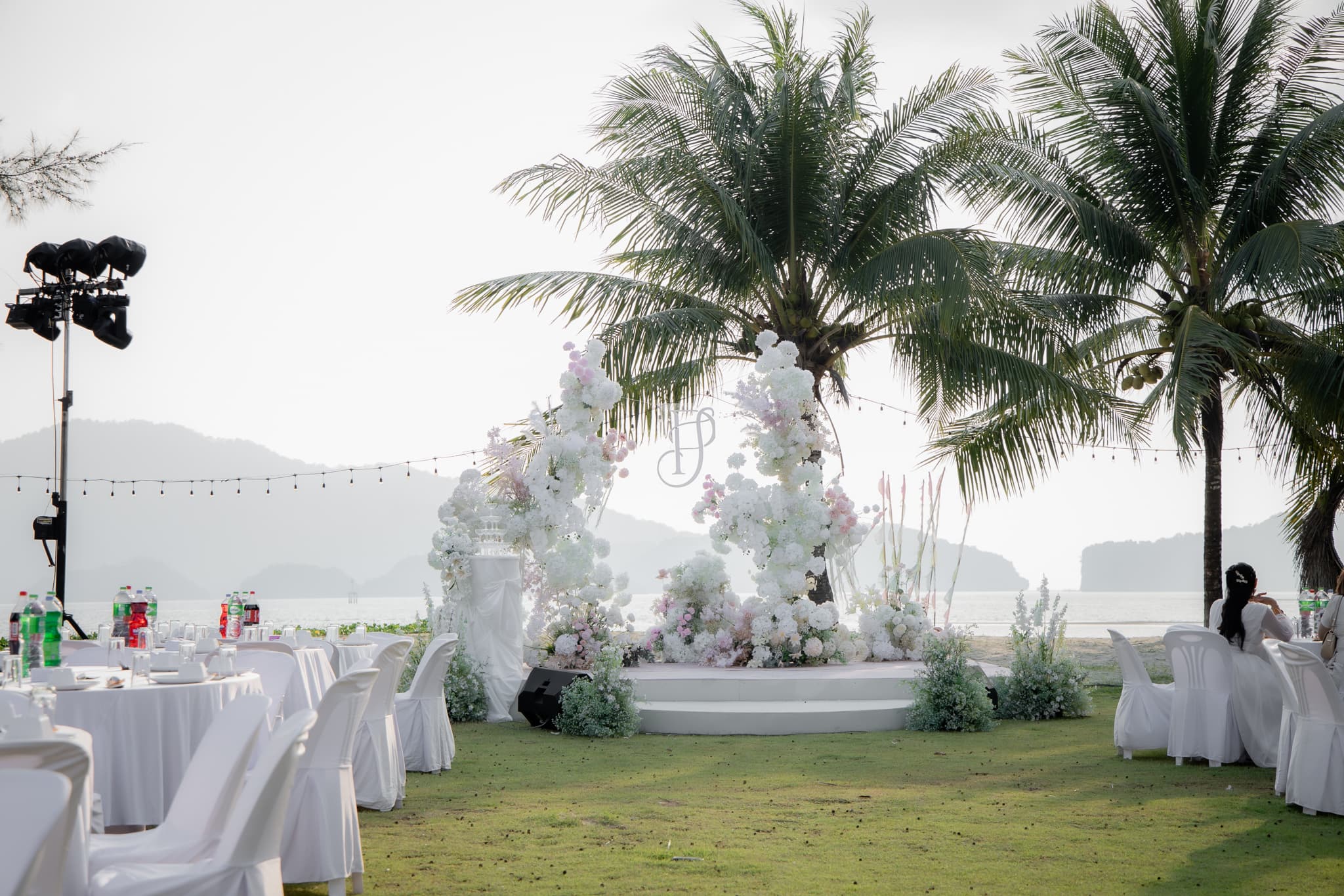 A seaside wedding ceremony set among palm trees at Seesea Resort